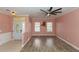 Spacious living room with wood floors, a unique fan, and a decorative deer mount at 112 Coral Reef Ct, Sanford, FL 32771