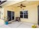 Cozy outdoor patio with tiled flooring, ceiling fan, and access to the backyard and interior at 112 Coral Reef Ct, Sanford, FL 32771