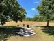 Outdoor picnic area featuring picnic tables, BBQ grill, and lush green space at 112 Coral Reef Ct, Sanford, FL 32771