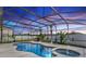 Stunning screened pool with a relaxing spa, lush landscaping, and serene evening ambiance at 112 Coral Reef Ct, Sanford, FL 32771
