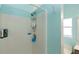 Walk-in shower with tile walls, blue accents, and a convenient storage caddy for toiletries at 112 Coral Reef Ct, Sanford, FL 32771