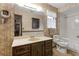 Traditional bathroom with wallpaper, dark wood vanity, and shower-tub combination at 1128 Heidi Ct, Deland, FL 32720