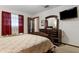 Cozy bedroom features plush carpeting, a dark dresser, and a mounted television at 1128 Heidi Ct, Deland, FL 32720
