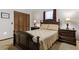 Comfortable bedroom with a queen bed, wooden furniture, and warm lighting at 1128 Heidi Ct, Deland, FL 32720