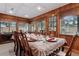 Formal dining room featuring wood paneled walls, a large table, and ornate chairs at 1128 Heidi Ct, Deland, FL 32720