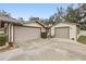 Home featuring a three-car garage with a large driveway at 1128 Heidi Ct, Deland, FL 32720