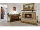 Cozy living room with a brick fireplace, mantle, and carpet at 1128 Heidi Ct, Deland, FL 32720