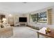 Cozy living room features lots of natural light and plush carpeting at 1128 Heidi Ct, Deland, FL 32720