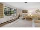 Bright living room featuring a large window and plush neutral carpet at 1128 Heidi Ct, Deland, FL 32720