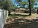 The expansive backyard features a beautiful lawn with a new white fence and screened-in patio at 1179 Heidi Ct, Deland, FL 32720