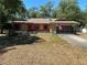 Charming single-story home featuring a well-maintained lawn, red shutters, and attached garage at 1179 Heidi Ct, Deland, FL 32720