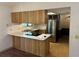 Bright kitchen with stainless steel appliances, light countertops, and wood cabinets at 1179 Heidi Ct, Deland, FL 32720