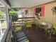 Inviting porch with charming yellow furniture perfect for outdoor dining and relaxation at 1179 Heidi Ct, Deland, FL 32720