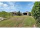 Expansive backyard with verdant lawn, lush trees, and serene lake views at 1188 Eggleston Dr, Deland, FL 32724