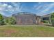 Lush backyard featuring a screened lanai and manicured landscaping at 1188 Eggleston Dr, Deland, FL 32724