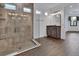 Bright bathroom featuring a glass shower stall, vanity with wood cabinets, ceramic tiles and wood-style floors at 1188 Eggleston Dr, Deland, FL 32724