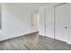 Bedroom features gray tile floors, base trim, white walls, closet and doorway to another room at 1188 Eggleston Dr, Deland, FL 32724