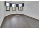 Bright bedroom featuring gray wood-style flooring, base trim, multiple windows and recessed lighting at 1188 Eggleston Dr, Deland, FL 32724