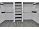 Walk-in closet featuring multiple levels of shelving and wood-style flooring at 1188 Eggleston Dr, Deland, FL 32724