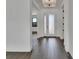 Bright foyer boasting stylish dark wood-look tile flooring and a decorative glass front door at 1188 Eggleston Dr, Deland, FL 32724