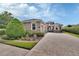Charming single-story home featuring a three-car garage, paved driveway, manicured landscaping, and stone accents at 1188 Eggleston Dr, Deland, FL 32724