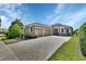 Charming, single-story home featuring a three-car garage, paved driveway, manicured landscaping, and stone accents at 1188 Eggleston Dr, Deland, FL 32724
