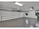 Large two car garage with white doors, ceiling fan and overhead storage at 1188 Eggleston Dr, Deland, FL 32724