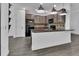 Modern kitchen featuring granite countertops, stainless appliances, and wood-look tile flooring at 1188 Eggleston Dr, Deland, FL 32724