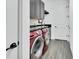 Convenient laundry room with modern red washer/dryer and sleek black countertops at 1188 Eggleston Dr, Deland, FL 32724