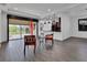 Open-concept living room with wood-look tile floors offering seamless access to the kitchen and screened patio at 1188 Eggleston Dr, Deland, FL 32724