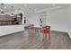 Bright living area with wood-look tile flooring adjacent to the kitchen with pendant lights and modern appliances at 1188 Eggleston Dr, Deland, FL 32724