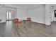 Spacious living room with wood-look tile flooring, a bright white wall and modern trim at 1188 Eggleston Dr, Deland, FL 32724