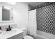 Modern bathroom featuring a shower-tub combo with decorative tiles and a vanity with sleek fixtures at 1202 Anderson St, Deltona, FL 32725
