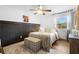 Cozy bedroom with wood paneling, a patterned rug, and a window providing natural light and street views at 1202 Anderson St, Deltona, FL 32725