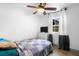Simple bedroom featuring a ceiling fan, neutral décor, and a window providing natural light and ventilation at 1202 Anderson St, Deltona, FL 32725