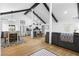 Bright open-concept living space featuring vaulted ceilings, wood floors, and modern furnishings at 1202 Anderson St, Deltona, FL 32725