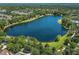 Beautiful aerial view of a serene lake surrounded by lush greenery and peaceful residential community at 1219 Victoria Hills N Dr, Deland, FL 32724