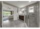 The bathroom includes a glass enclosed shower, vanity with dark cabinets, and access to the main bedroom at 1219 Victoria Hills N Dr, Deland, FL 32724