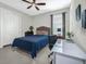 Cozy bedroom featuring a comfortable bed, a white desk, and natural lighting from the window at 1219 Victoria Hills N Dr, Deland, FL 32724