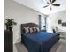 Spacious bedroom with a ceiling fan, a comfortable bed, and natural lighting from the window at 1219 Victoria Hills N Dr, Deland, FL 32724