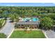 Aerial view of community center featuring a large pool, beautiful landscaping, and well-maintained grounds at 1219 Victoria Hills N Dr, Deland, FL 32724