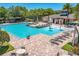 Inviting community pool featuring a splash fountain, comfortable lounge chairs, and shaded seating areas at 1219 Victoria Hills N Dr, Deland, FL 32724