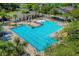 Stunning aerial view of a resort-style community pool with ample seating, lush landscaping, and water features at 1219 Victoria Hills N Dr, Deland, FL 32724