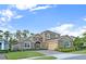 Charming two-story home featuring stone accents, a well-manicured lawn, and a brick paved driveway at 1219 Victoria Hills N Dr, Deland, FL 32724