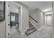 Hallway leading to carpeted stairs and a bathroom, offering a bright, spacious feel at 1219 Victoria Hills N Dr, Deland, FL 32724