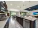 Modern kitchen with stainless steel appliances, a large island, and an adjacent living room at 1219 Victoria Hills N Dr, Deland, FL 32724