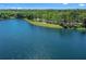 Scenic view of a tranquil lake featuring a picturesque shoreline with trees and walking path at 1219 Victoria Hills N Dr, Deland, FL 32724