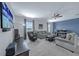 Spacious living room with plush seating, ceiling fan, and large TV for comfortable entertainment at 1219 Victoria Hills N Dr, Deland, FL 32724