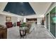 Open living space with a blue tray ceiling, tile floors, and seamless flow to the kitchen and patio at 1219 Victoria Hills N Dr, Deland, FL 32724