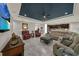 Bright living room with tiled flooring, tray ceiling, seamlessly connected to an open kitchen at 1219 Victoria Hills N Dr, Deland, FL 32724